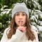 Woman in “quiet” pose with index finger raised