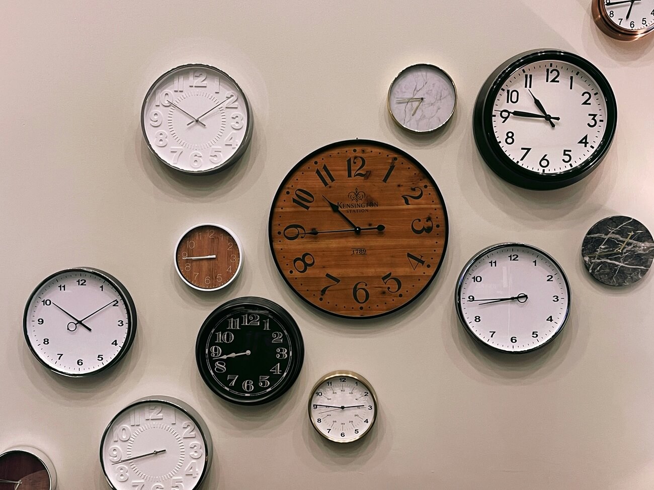 Many clocks hang on the wall.