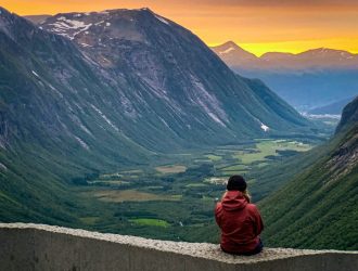 The back view of a woman gazing at the mountain.
