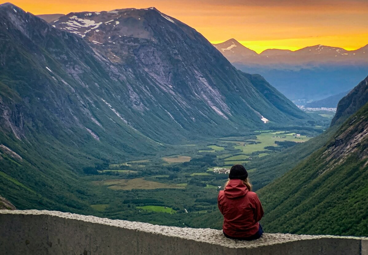 The back view of a woman gazing at the mountain.
