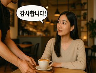 A woman receiving coffee from a barista at a cafe and saying thank you